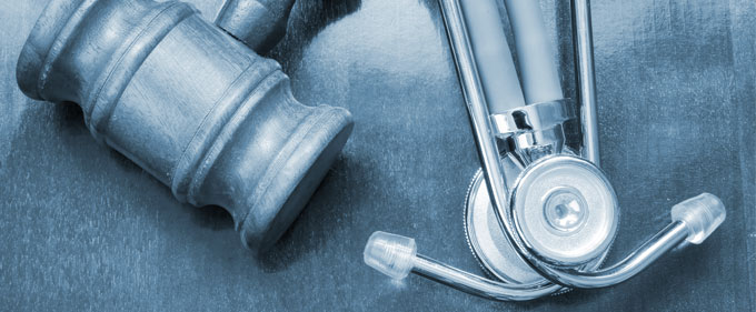 Gavel and stethoscope with blue tint